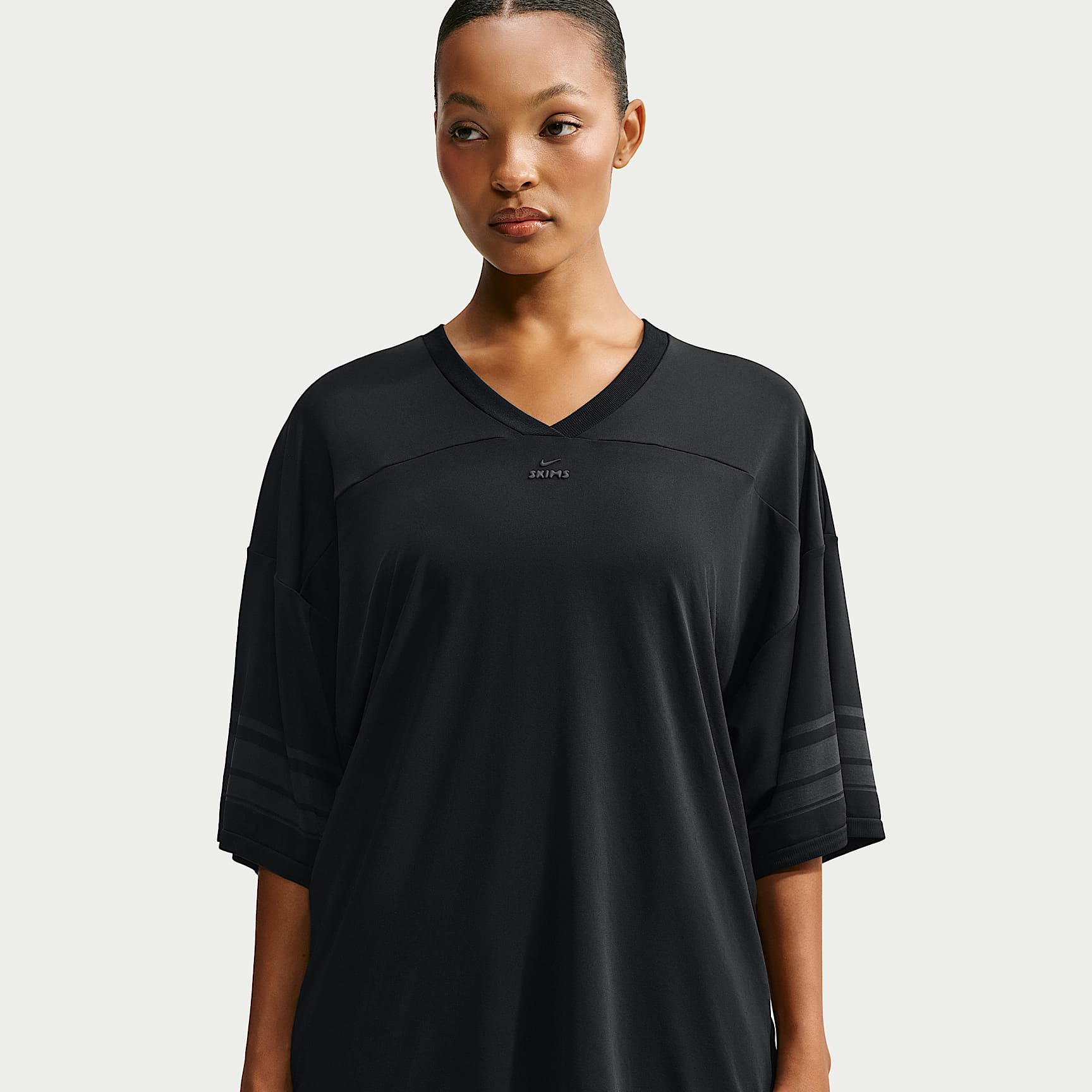 NikeSKIMS Stretch Knit Women's Oversized V-Neck Top. Nike IE